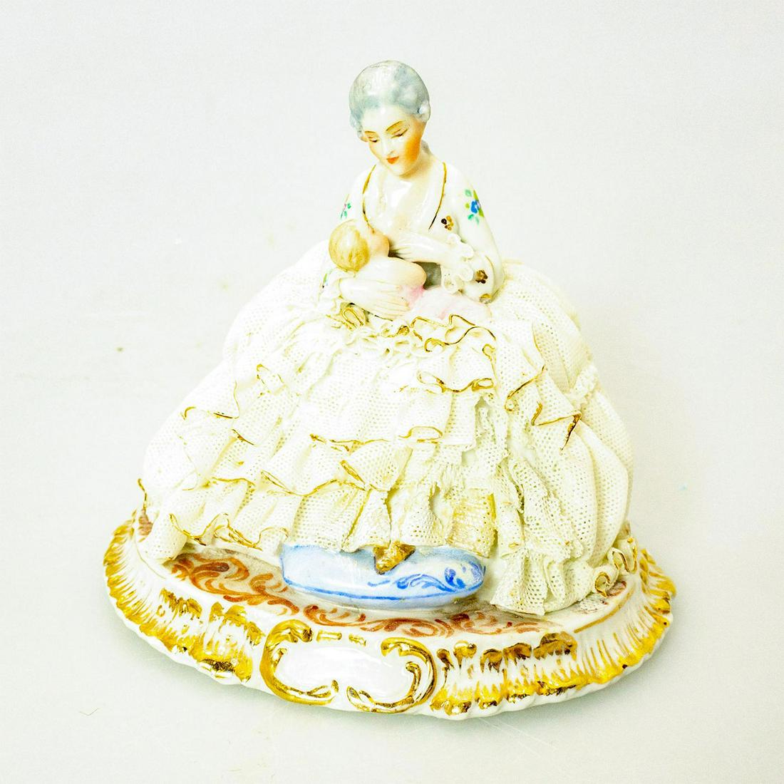 Luigi Fabris Figurine, Mother And Child: Mother nursing her child. Finely painted floral pattern; porcelain lace dress; gilt accents. L Fabris backstamp. Broken lace on gown. Artist: Luigi Fabris Issued: 20th c. Dimensions: 4.75"H Country of