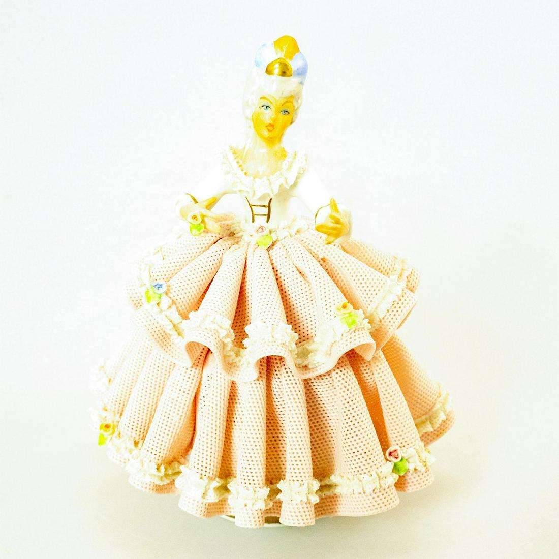 Vintage Sandizell Porcelain Lady Figurine: Hand painted; porcelain lace gown. Pink and white coloration; adorned with roses. Sandizell backstamp. Chipped lace. Issued: 20th c. Dimensions: 5.5"H Manufacturer: Sandizell Porcelain Country of Orig