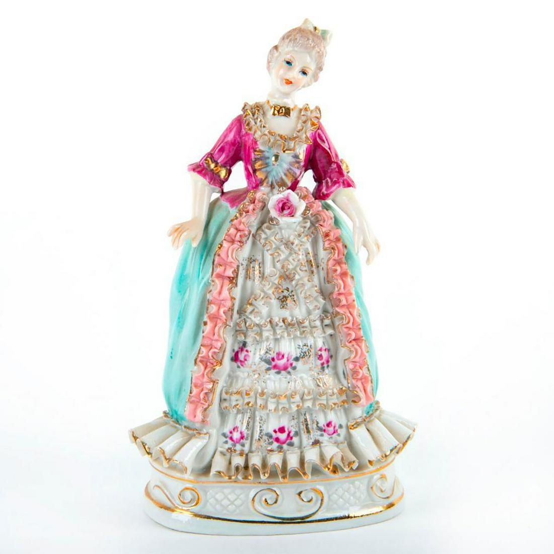 Vintage English Bone China Lace Lady Figurine: Pink and blue coloration; ruffled lace detail; gilt accents. Crossed swords backstamp. Age related wear. Issued: 20th c. Dimensions: 8.25"H