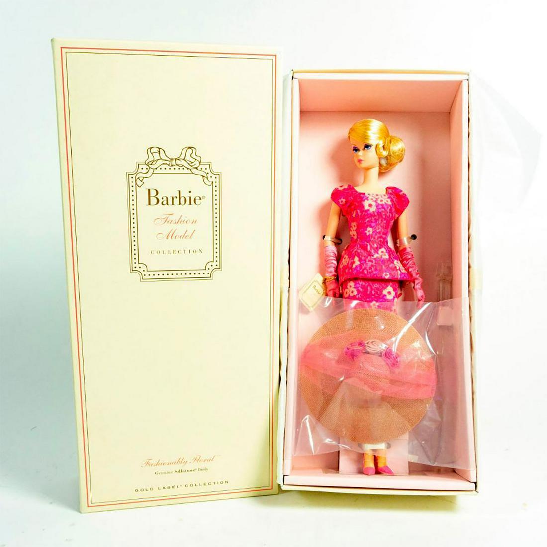 Fashionably Floral Barbie Doll: W/ Box. Barbie doll's intricately crafted ensemble includes a beautiful floral print dress featuring puff sleeves, cinched waist and tufted back pleats. The opera-length gloves are made of shirred cha