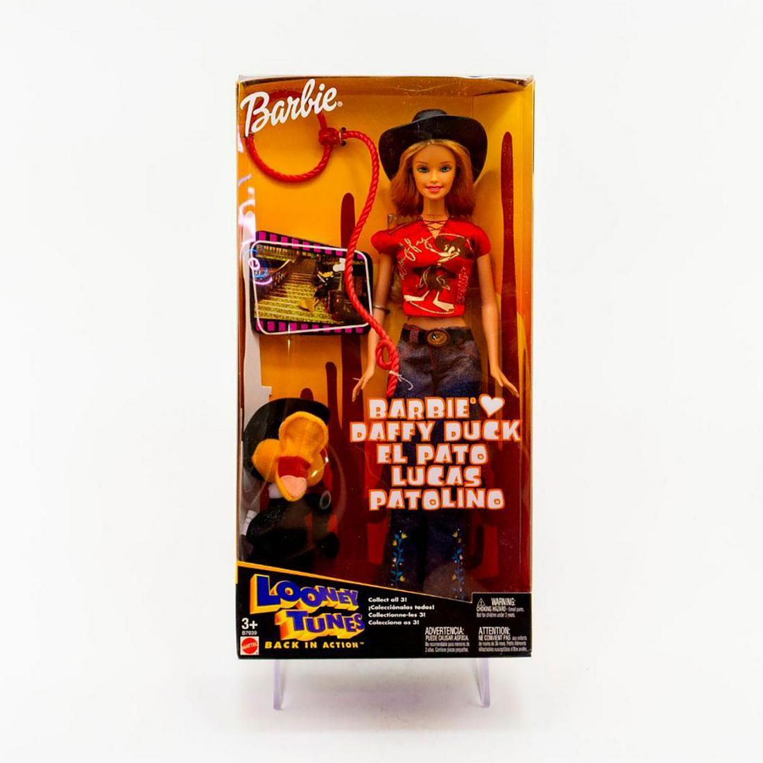 Mattel Looney Tunes Barbie Doll, Barbie Loves Daffy: Barbie Doll dressed in a Daffy Duck pattern top. Includes plush Daffy Duck doll. Looney Tunes Back In Action. Housed in original box. SKU #B7039 Issued: 2003 Dimensions: 13"H Manufacturer: Mattel Coun