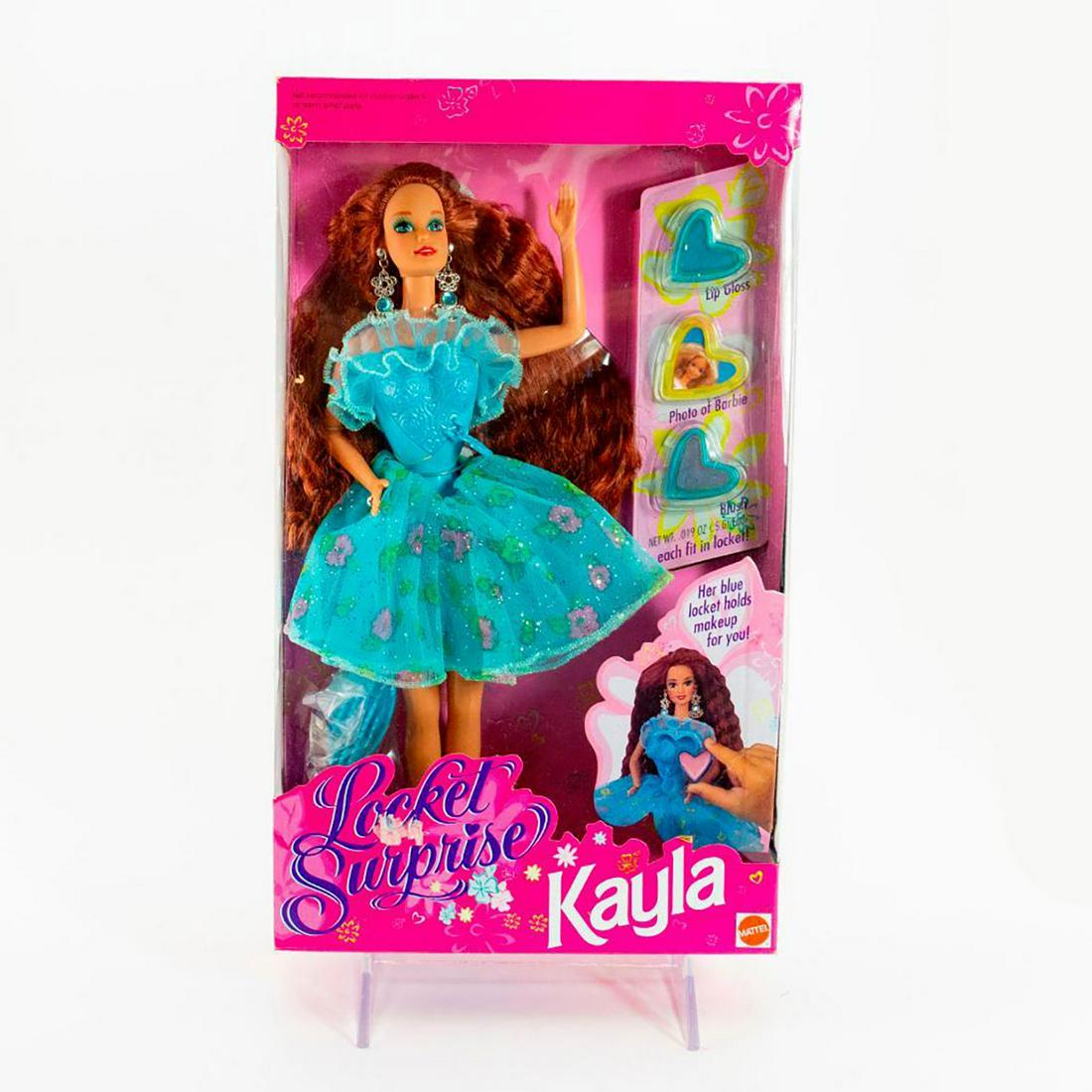 Mattel Kayla Doll, Locket Surprise: Kayla has a tulle skirt and ruffle above her solid bodice with a secret compartment which opens. SKU #11209. #barbie Issued: 20th c. Dimensions: 12"H Manufacturer: Mattel Country of Origin: China