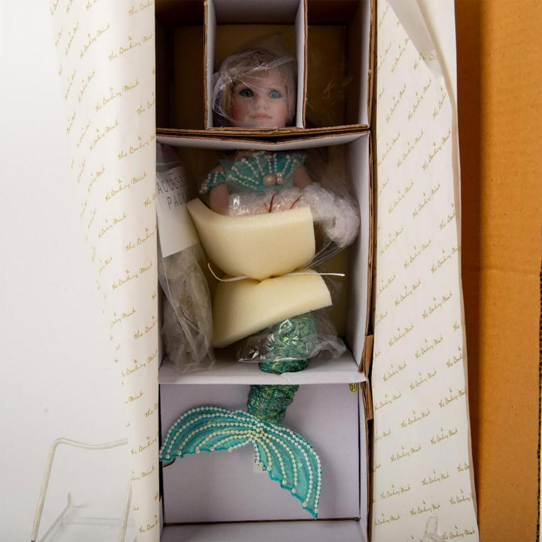 Danbury Mint Serena Doll: Serena Doll in teal mermaid outfit; Sequins and gold harp in hand. With original box. Artist: Judy Belle Issued: 1990's Dimensions: 19"L Manufacturer: Danbury Mint Country of Origin: China