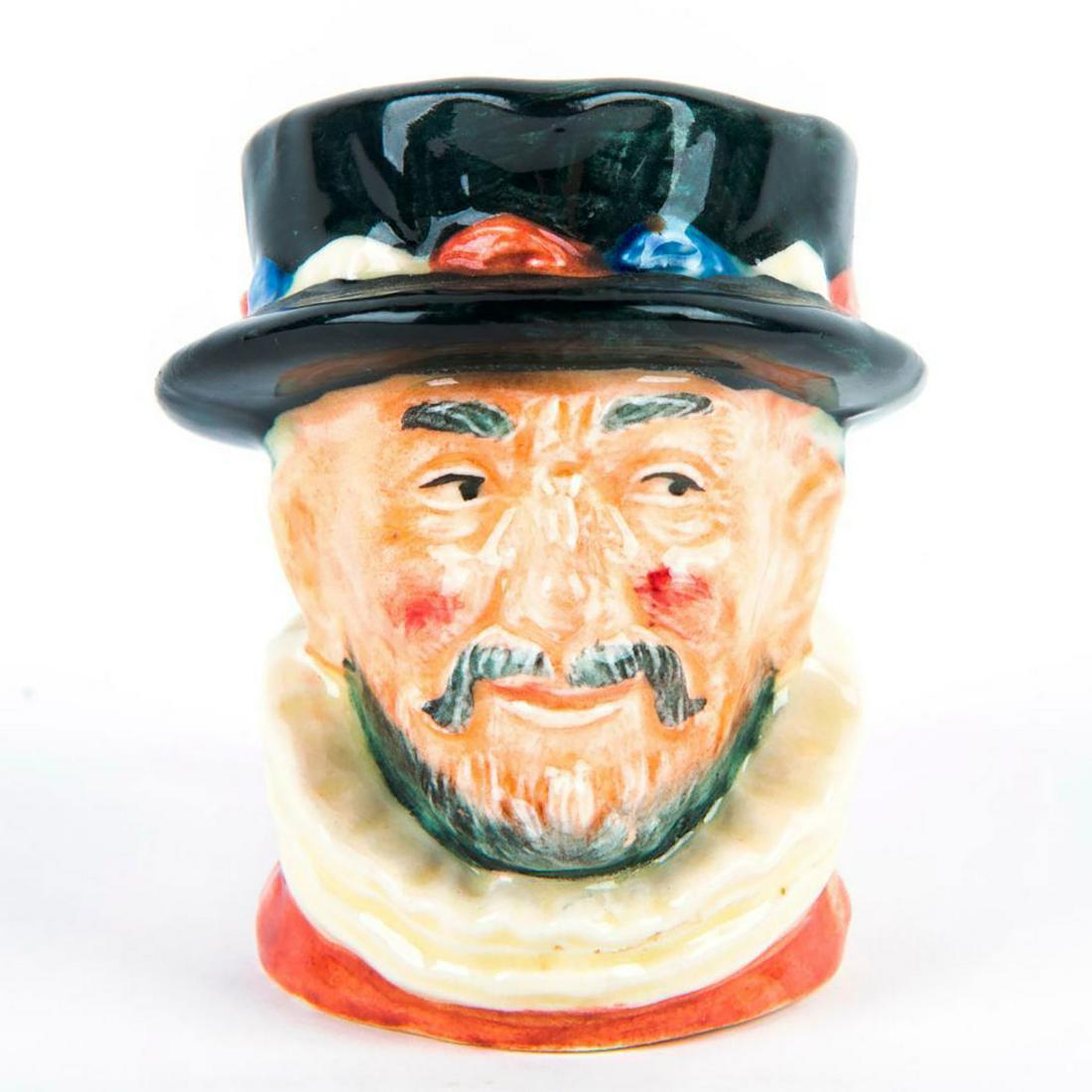 Beefeater ER D6251 - Mini - Royal Doulton Character Jug: Pink tunic; designed with embossed ER cipher to handle. Royal Doulton backstamp. Marked Doulton & Co Limited to bottom base. Artist: Harry Fenton Dimensions: 2.75"H Manufacturer: Royal Doulton Country