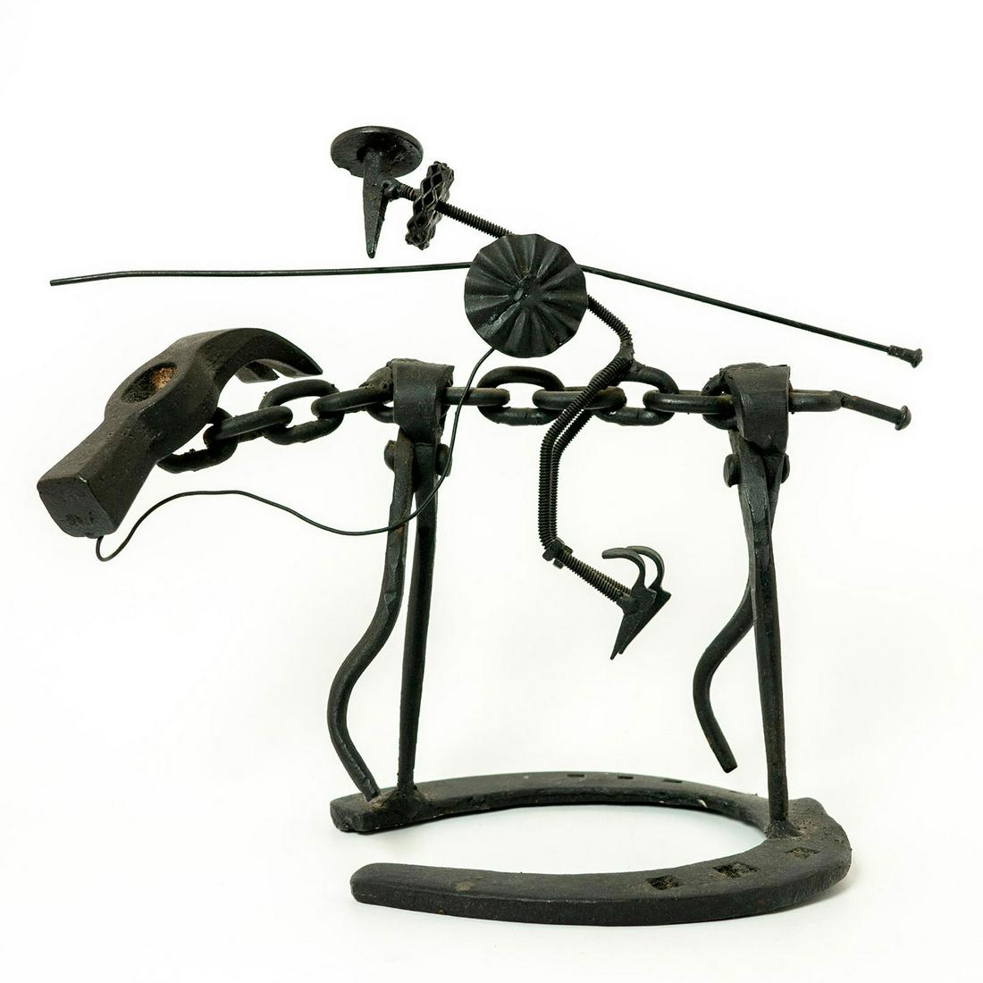 Metal Art Sculpture Figurines, Don Quixote: Hand-crafted black metal art work comprising of a horseshoe base, nails, hammer head, nuts and bolts. Unmarked. Issued: 20th c. Dimensions: 12.25"L x 10"H