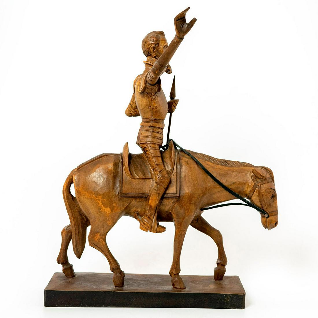 Ouro Artesania Carved Wood Figurine, Don Quixote: Exquisitely detailed wood carving of the of Don Quixote of La Mancha with spear on his horse. Numbered 582-A. Stamped Ouro Artesania on base. Loose/removable right arm. Issued: 20th c. Dimensions: 13"