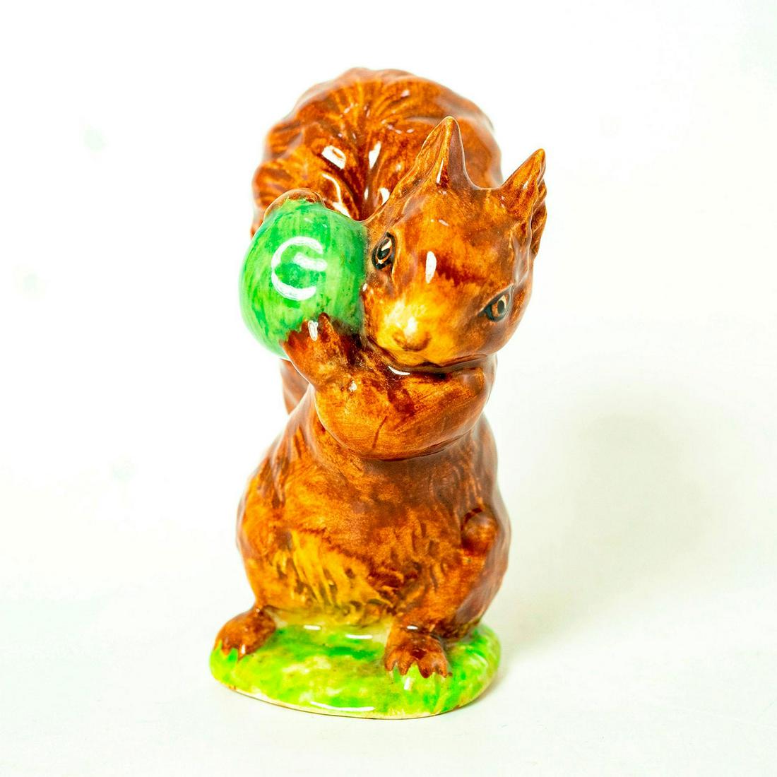 Squirrel Nutkin (GreenApple) - Beswick - Beatrix Potter: Beswick backstamp. Gold brown squirrel holding green apple. Artist: Arthur Gredington Issued: 1980 - 2000 Dimensions: 3.75"H Manufacturer: Beswick Country of Origin: England
