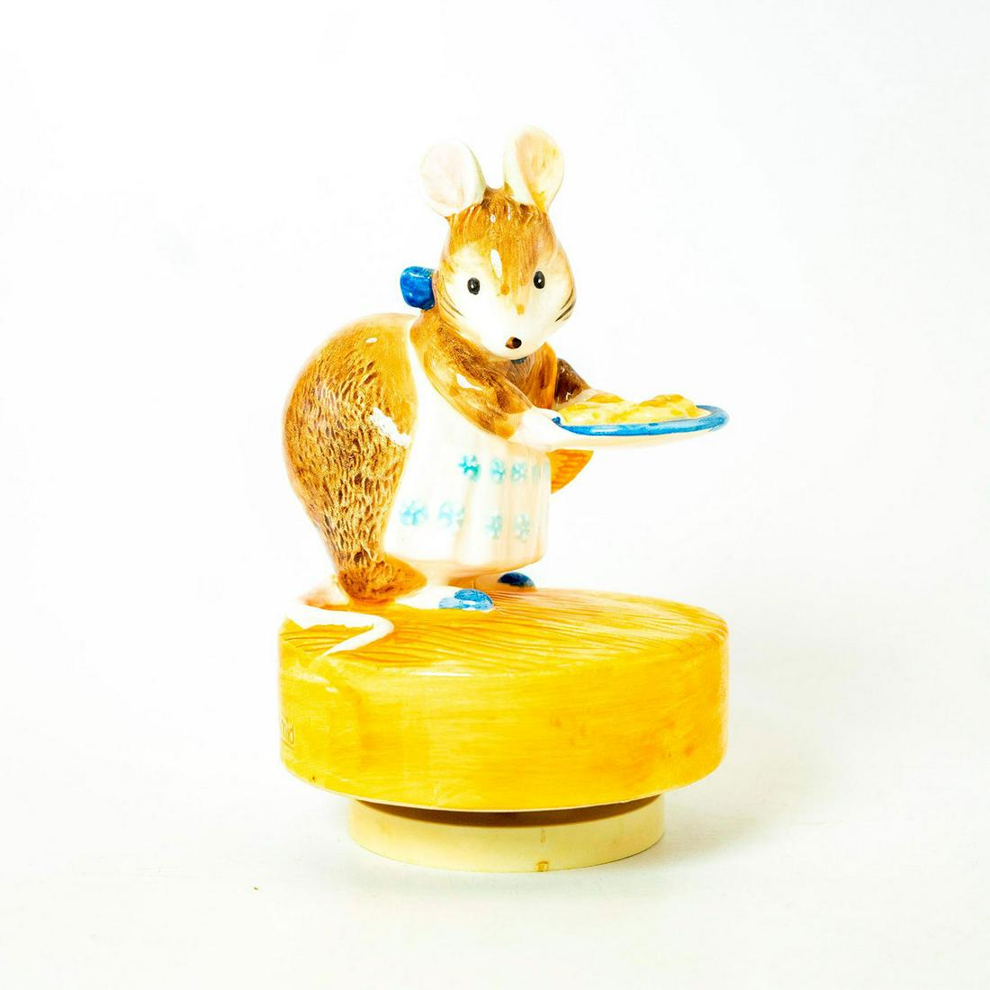 Schmid Music Box, Beatrix Potter, Appley Dapply: Mouse holding treats on a tray standing on rotating base as music plays. Schmid backstamp. Original manufacture's label. Inscription on side reading 'Appley Dapply, Beatrix Potter, schmid'. Issued: 19