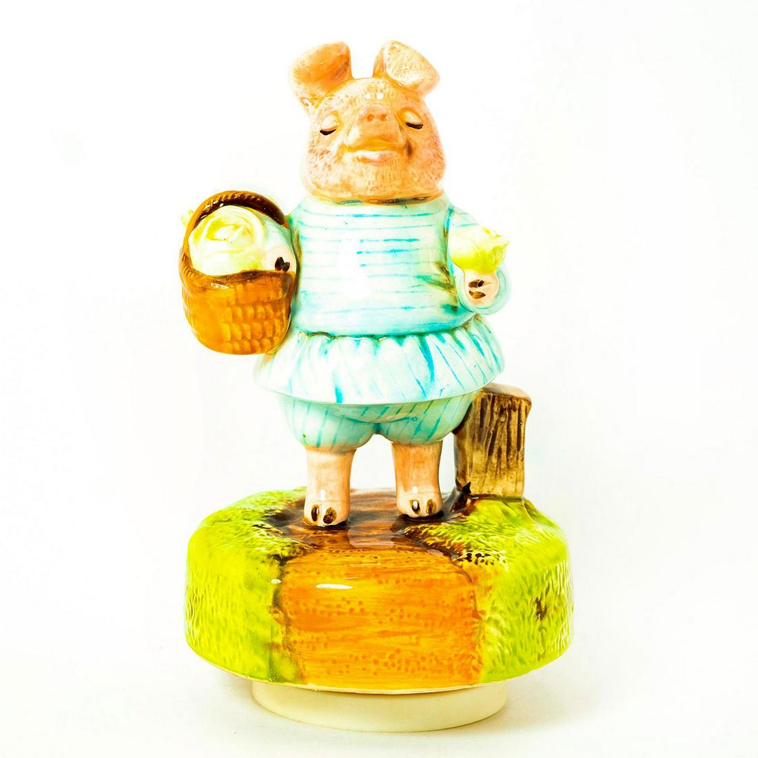 Schmid Music Box, Beatrix Potter, Little Pig Robinson: Pig in blue dress holding veggies stands on rotating music box. Schmid backstamp. Original manufacture's label. Inscription reading 'Little Pig Robinson, Beatrix Potter'. Issued: 1991 Dimensions: 7.5"
