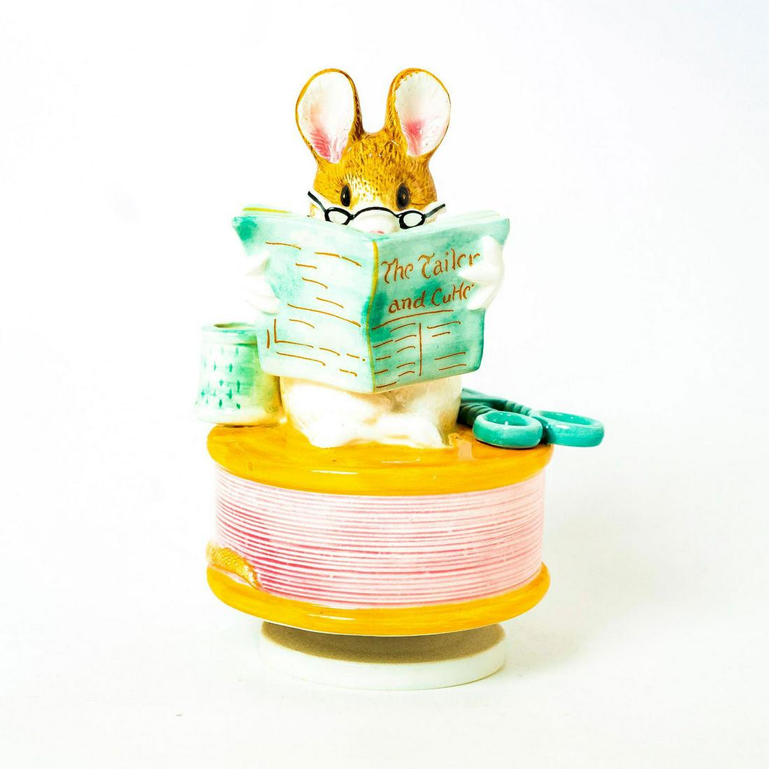 Schmid Music Box, Beatrix Potter, The Tailor of: Mouse reading 'The Tailor and Cutter' sits on rotating base. Schmid backstamp. Inscription on side reading 'Tailor of Gloucester, Schmid, Beatrix Potter'. Issued: 1978 Dimensions: 7"H Manufacturer: Sc