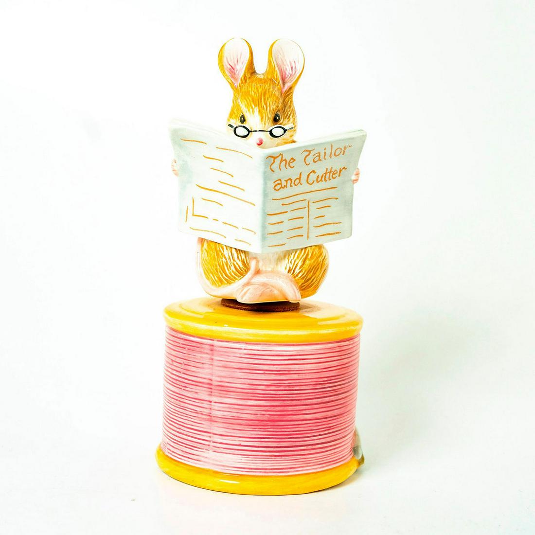 Schmid Music Box, Beatrix Potter, The Tailor of: Mouse reading 'The Tailor and Cutter' sits on rotating base. Schmid backstamp. Original manufacture's label. Inscription on side reading 'Beatrix Potter, Schmid'. Issued: 1989 Dimensions: 9"H Manufact
