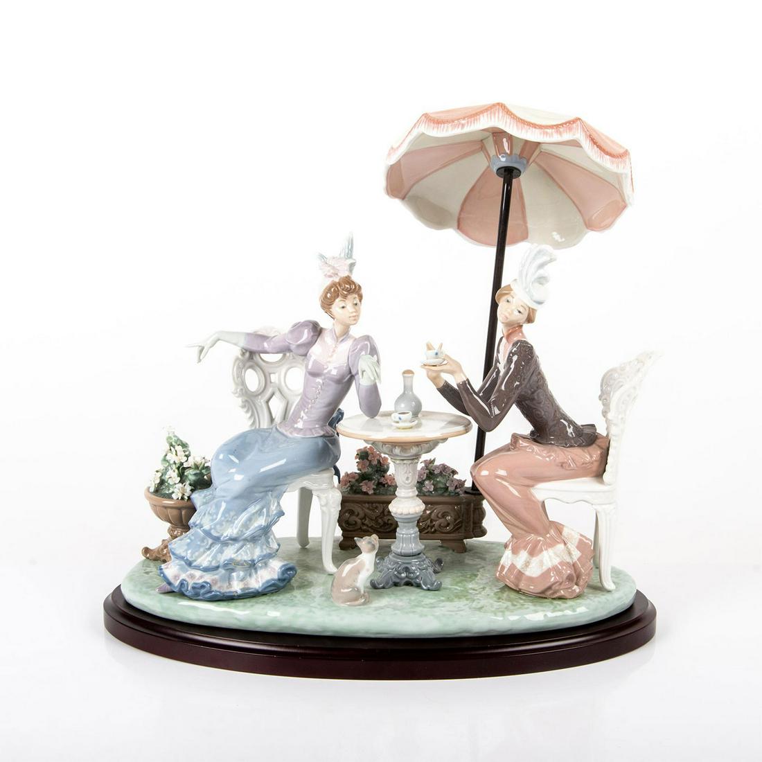 Cafe de Paris 01001511 - Lladro Porcelain Figurine: Glazed porcelain. Modelled as two women having tea. Includes base. Soft pastel cooration; delicate flowers. Lladro backstamp. Chipped petal. Artist: Salvador Debon Issued: 1987-1995 Dimensions: 13.25"