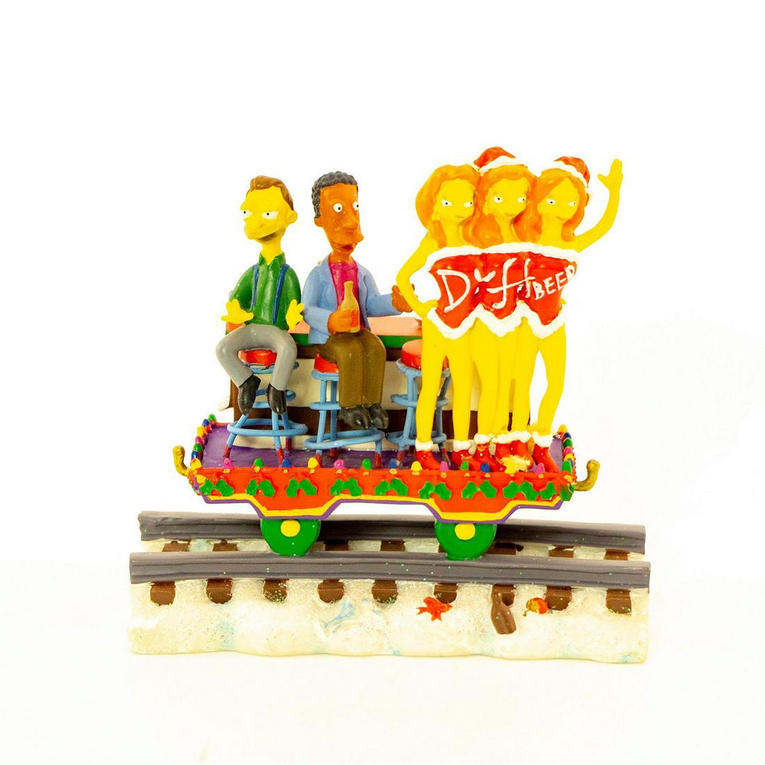 The Simpsons - Duffin Thru A Winter Wonderland Figurine: Matte finished figurine; Simpson character's on parade float of car train on train tracks. Box included. Issued: 2003 Dimensions: 3"H Manufacturer: Hamilton Collection Country of Origin: China