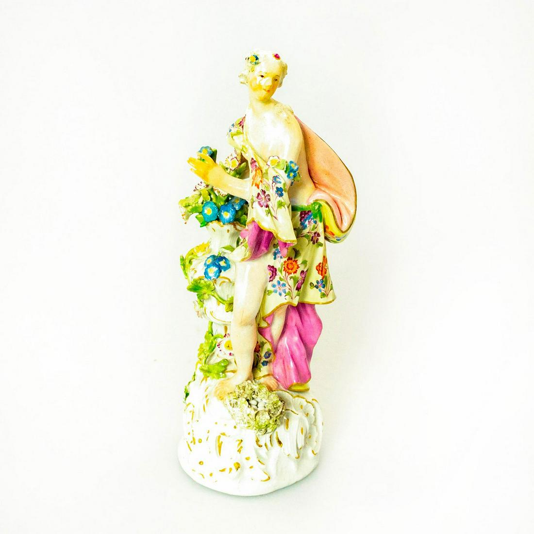 Meissen Style Porcelain Figurine Floral Walk: Glossy porcelain figurine of a lady draped in floral garments passing a planter. Issued: 20th c. Dimensions: 9"H Country of Origin: Germany