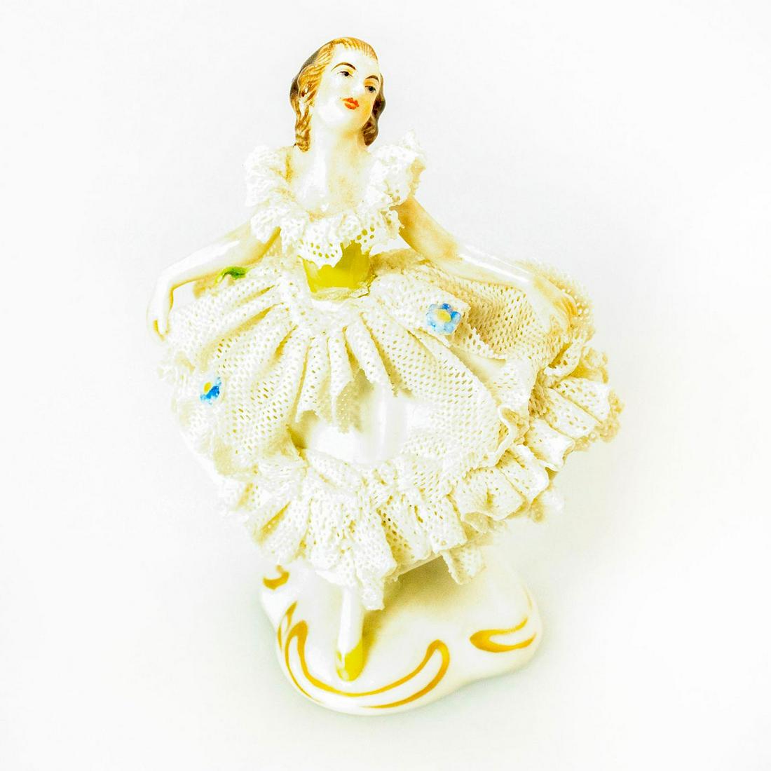 Volkstedt Porcelain Figurine Ballet Dancer: Glossy porcelain miniature figurine. Flowers on dress. Gold gilt accents on base. Chipped lace dress. Issued: 20th c. Dimensions: 3.5"H Manufacturer: Volkstedt Country of Origin: Germany
