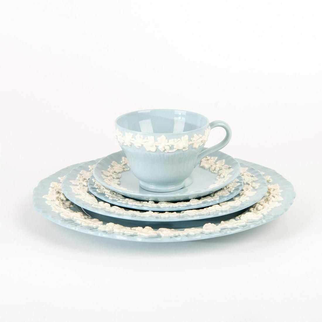 40 Pc Wedgwood Queensware Blue And White China Service: Stunning set includes 8 cups, 8 saucers, 8 salad plates, 8 dessert plates and 8 dinner plates. Embossed Queensware; blue ground with grape and vine design in relief. Wedgwood backstamp. Largest plate 