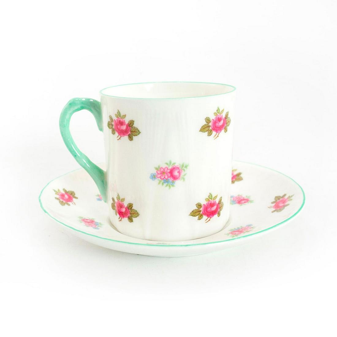 Shelley Fine Bone China Cup And Saucer, Rosebud: Rosebud pattern; no. 13426. Glazed bone china cup and saucer, with pink and blue flora; green trim. Shelley backstamp. Issued: 20th c. Dimensions: 2.25"H x 4.75" dia. Manufacturer: Shelley China Count