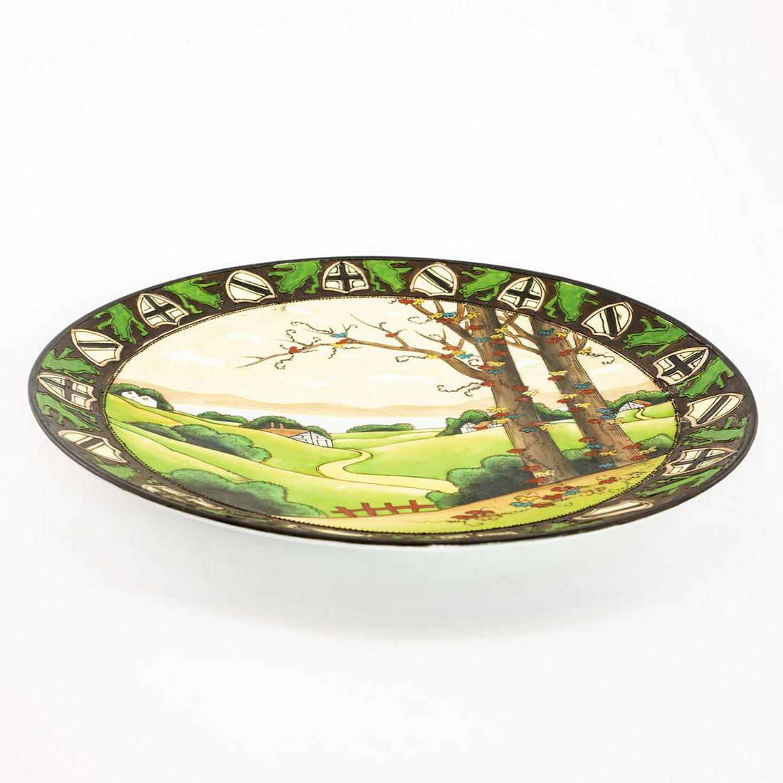 Nippon Porcelain Decorative Plate: Porcelain decorative plate with a country scene of rolling hills. A band of shields wraps the rim. Nippon backstamp Issued: 19th c. Dimensions: 11" dia. Manufacturer: Nippon Country of Origin: Japan