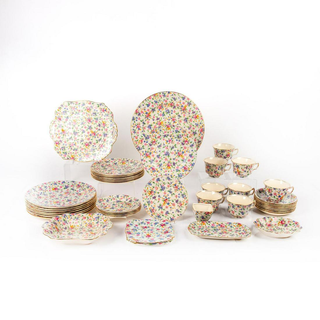 43pc Royal Winton China Dinnerware: Porcelain dishware with floral decoration and gold gilt accent. Old Cottage Chintz. Royal Winton backstamp. Issued: 19th c. Manufacturer: Royal Winton Country of Origin: England
