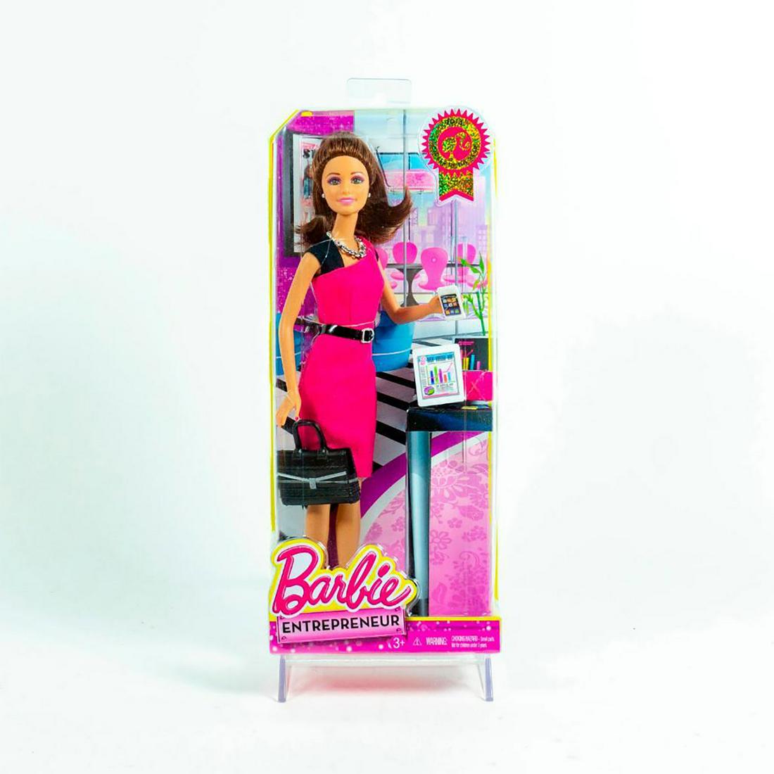 Barbie Doll, Entrepreneur: She wears a sleek pink and black dress and includes smartphone, tablet and briefcase. SKU #CCJ45. #barbie Issued: 21st c. Dimensions: 12"H Manufacturer: Mattel Country of Origin: China
