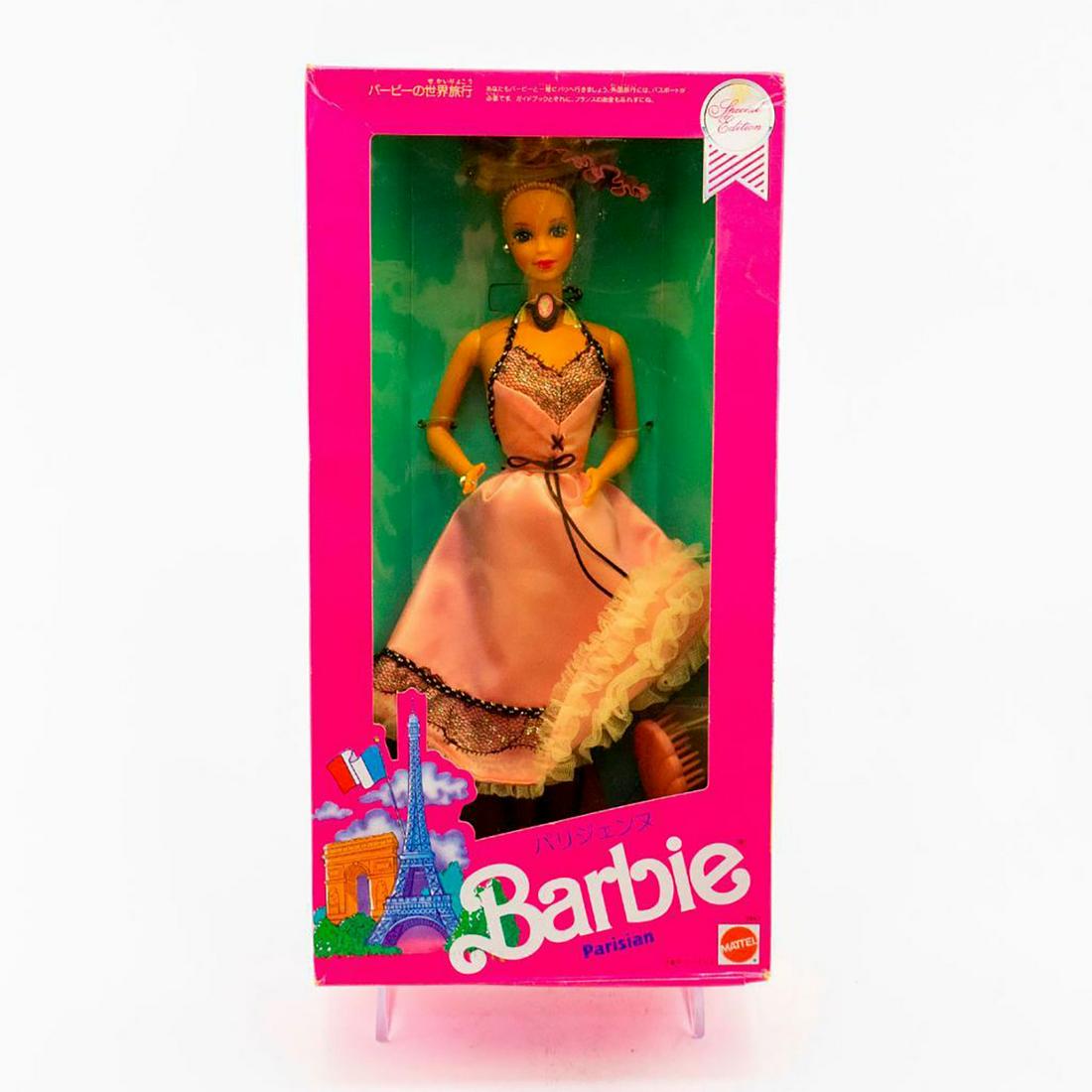 Mattel Barbie Doll, Parisian Barbie: Barbie dressed in a pink dress with black lace detail. Includes hair brush. Housed in original box. SKU #9843 Issued: 1990 Dimensions: 13"H Manufacturer: Mattel