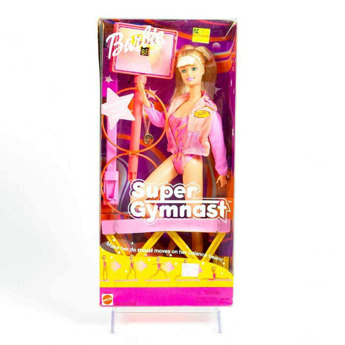 Mattel Barbie Doll, Super Gymnast: 11.5" poseable Barbie doll with scoreboard and medal. Includes original accessories. SKU #55290. Housed in original box. Issued: 2001 Dimensions: 13"H Manufacturer: Mattel Country of Origin: Indonesia