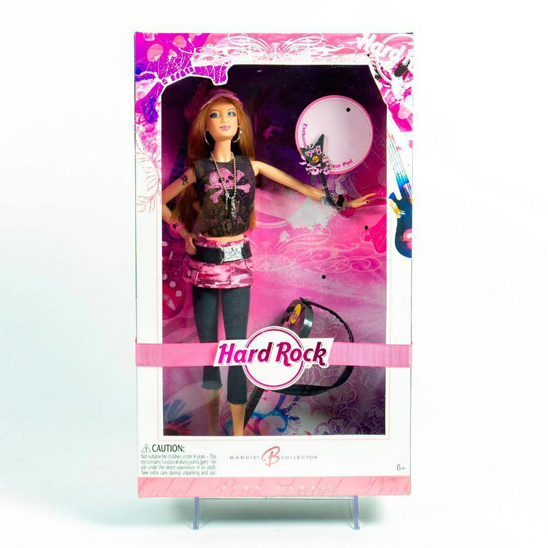 Mattel, Hard Rock Barbie Doll: Barbie is ready to rock! Pink and black punk rock outfit. Silver accents; guitar included. Also included Collector Pin. With original box. SKU #K7906. Issued: 2006 Dimensions: 13"H Manufacturer: Matte