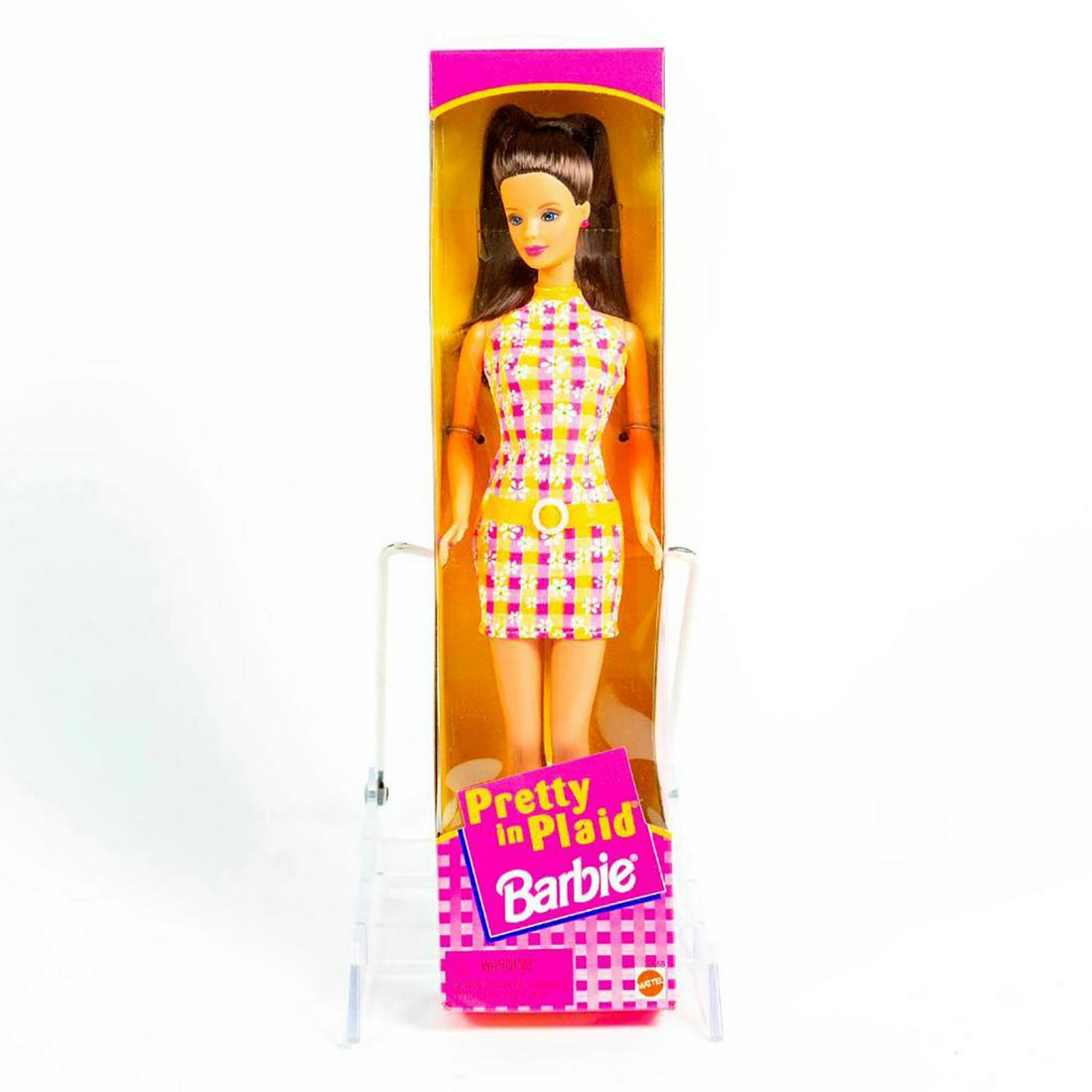 Mattel, Pretty in Plaid Barbie Doll: Barbie in pink and orange; white flowers. Orange belt. With original box. SKU #20668. Issued: 1998 Dimensions: 13"H Manufacturer: Mattel Country of Origin: China