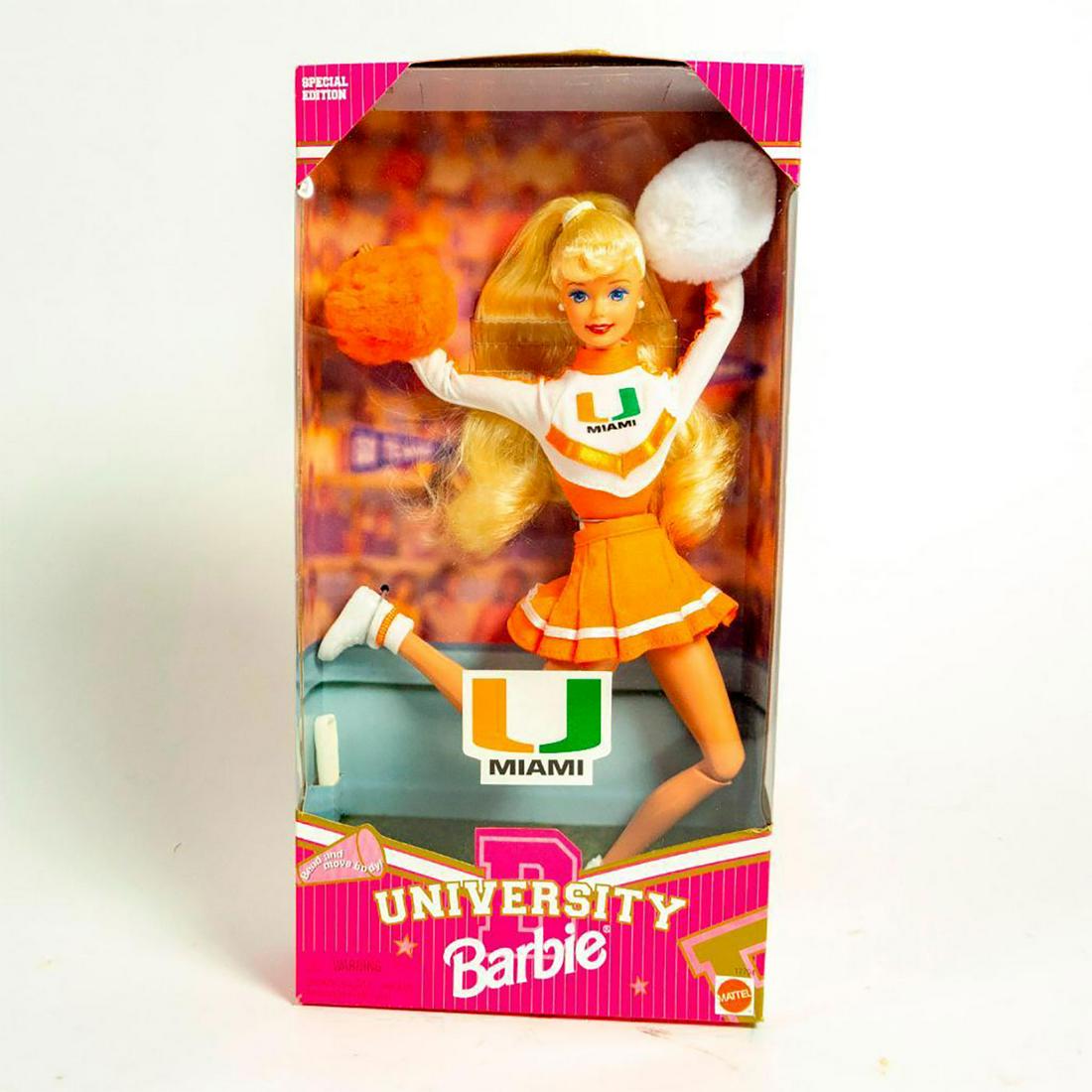 University Of Miami Cheerleader Barbie Doll: Barbie in a University of Miami cheerleader uniform with pom poms. Hairbrush included. With original box. #barbie #workoutbarbie #sportsbarbie SKU #17794 Issued: 1996 Dimensions: 10"H Manufacturer: Ma