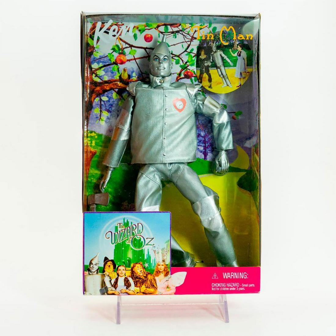Mattel Ken Doll as Tin Man from The Wizard of Oz: Ken in the iconic silver costume with an ax and an oil can. With original box. SKU #25815 #26384 Issued: 21st c. Dimensions: 12"H Manufacturer: Mattel Country of Origin: China