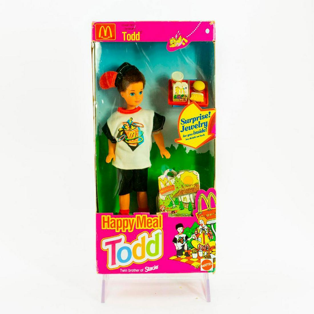 Mattel Todd Doll, Happy Meal Todd: Little Todd wears his McDonald's shirt, getting ready to eat his Happy Meal. SKU #11475. Issued: 20th c. Dimensions: 9.5"H Manufacturer: Mattel Country of Origin: Malaysia