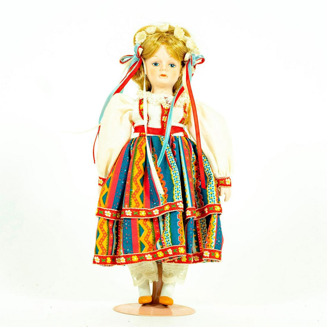 Vintage Doll, Gorham, Lovely Marya: Collectible doll in polish patterned dress with flowers and ribbons in hair. Original label attached to right arm. Original warning label attached to right arm. Original tag under dress. Attached to s