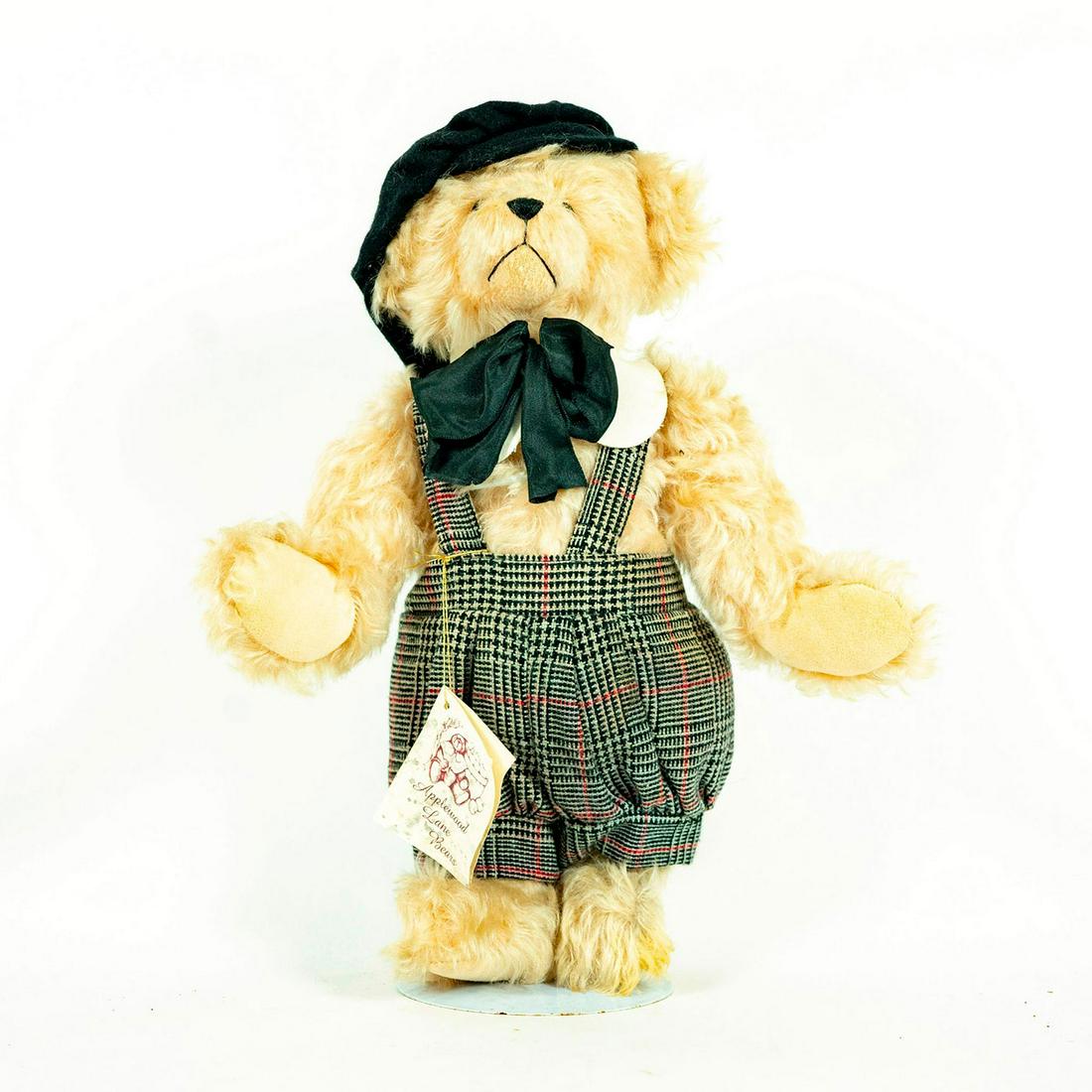 Applewood Lane Bears, Matthew: Light brown bear; Black and brown checkered outfit and black hat. Black bowtie. With stand. Artist: Joan Davis Issued: 20th c. Dimensions: 14"H Manufacturer: Applewood Lane Bears Country of Origin: US