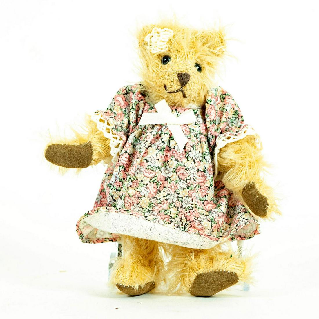 Leven Sonneberg Hermann Small Teddy Bear: Blonde Mohair, soft suede paw pads, black glass eyes dressed in a pink floral dress. Moveable arms and legs. Gilded, numbered 2129 Leven neck mark. Includes traditional red Sonneberg hang tag. Issued: