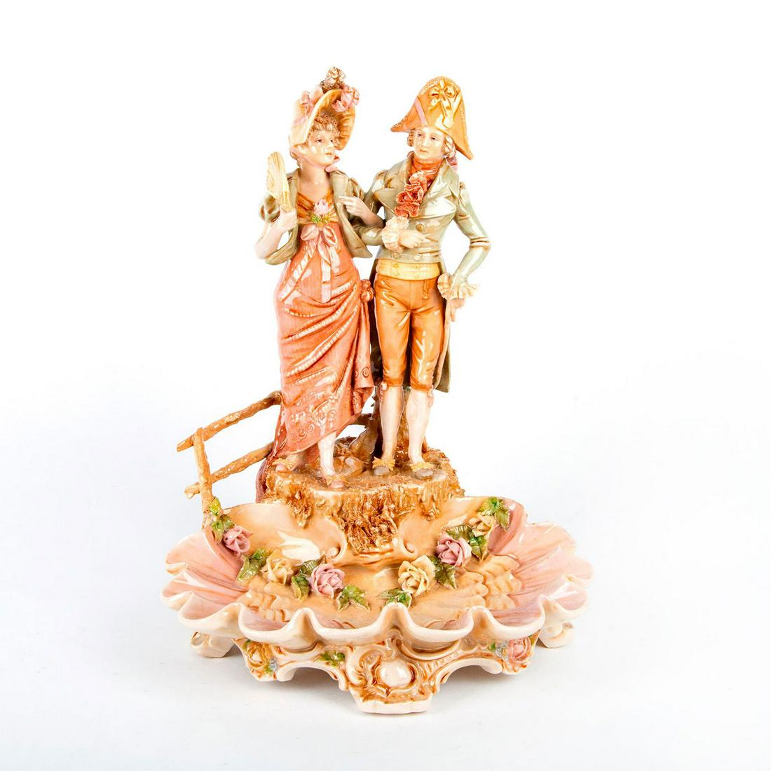 Royal Dux Bohemia Figurine and Scalloped Basin: High gloss finish; Muted color palette of greens, reds and tans. Royal Dux Bohemia stamp. Lower fence post on back restored. Issued: 19th c. Dimensions: 14.5"H Manufacturer: Royal Dux Bohemia Country 