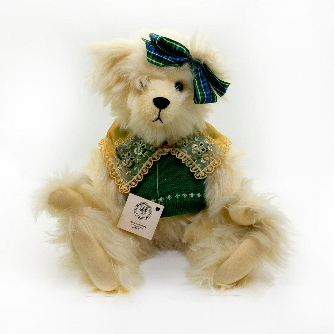 E. Willoughby Bear Company Teddy Bear, Hilda: Fully jointed, white mohair, glass eyes. Wearing a elegant lace scarf on top of a beautiful green knitted sweater. Brass colored pin holding the scarf together. Tasteful plaid hair tie to match the sw