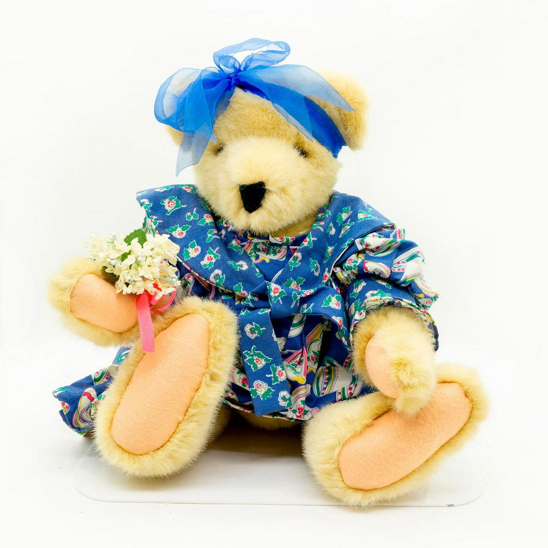 North American Bear Co Teddy Bear, Teacup: Blue floral dress with blue satin ribbon. Bouquet of white flowers attached to right hand. The Teacup collection. Fully jointed. Manufacturer tag placed in left sleeve. Artist: Odl Bauer Manufacturer: