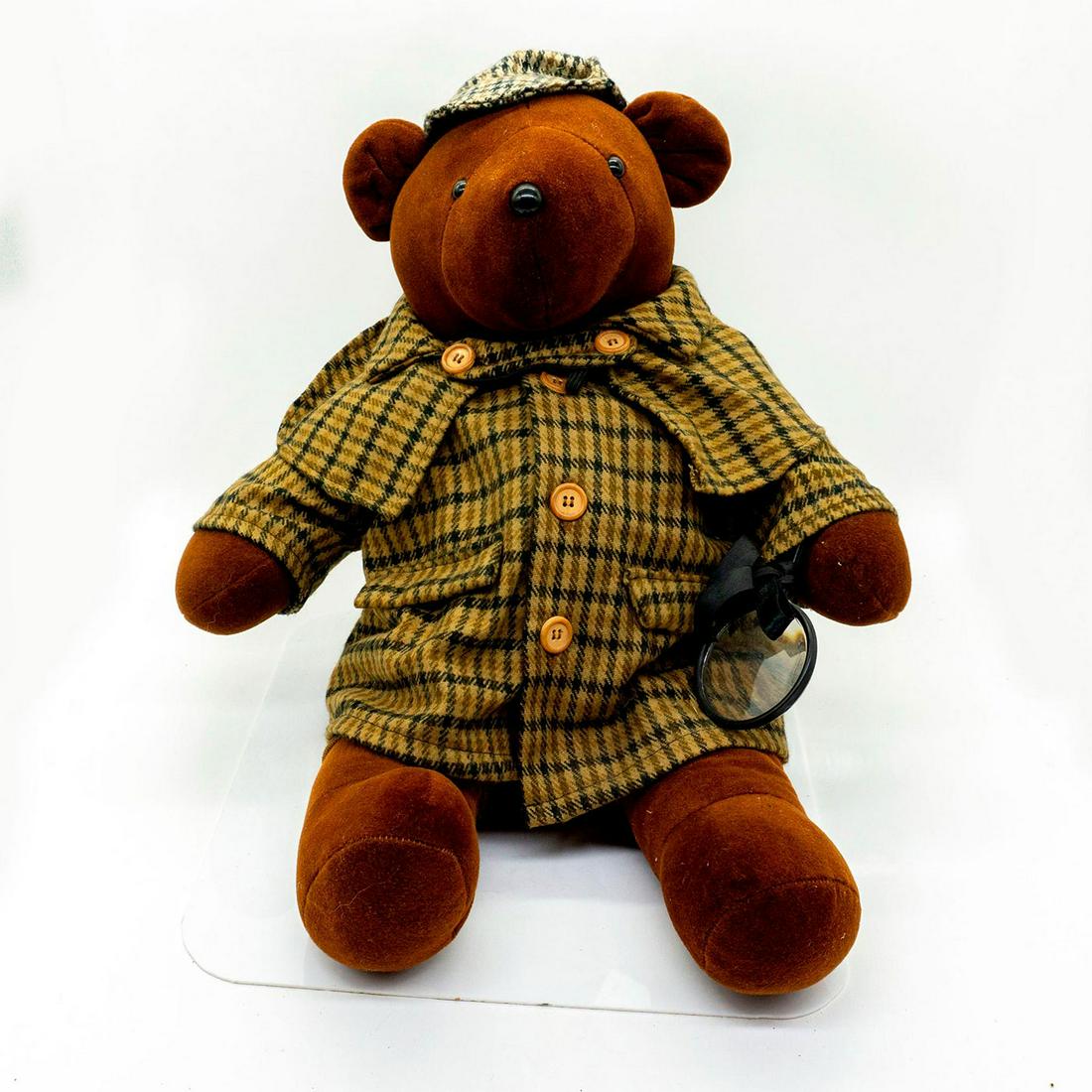 North American Bear Company Teddy Bear, Bearlock Holmes: Plush, wearing a detective's outfit and holding a magnifying glass. Original tag included. Issued: 20th c. Dimensions: 21"H Manufacturer: North American Bear Company Country of Origin: United States