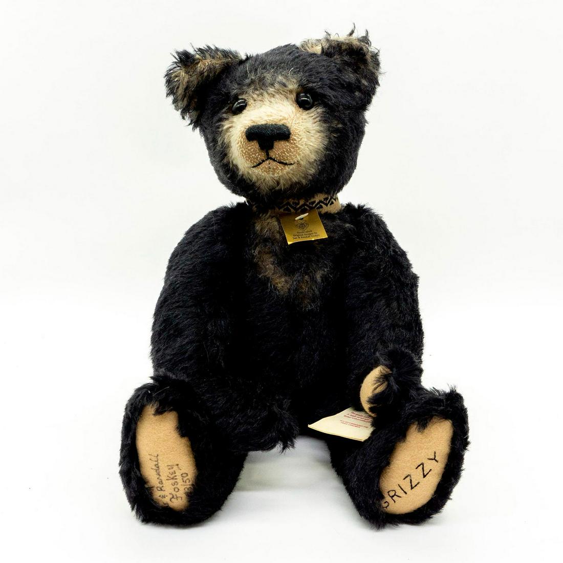 Nostalgic Bears, Black Grizzy Teddy Bear: Collectible stuffed animal is made of all new material, 100% Mohair and glass eyes. Suede feet and paws. -Grizzy- stitched to the one foot, Sue and Randall Foskey 13/50 writing on the other foot. Come