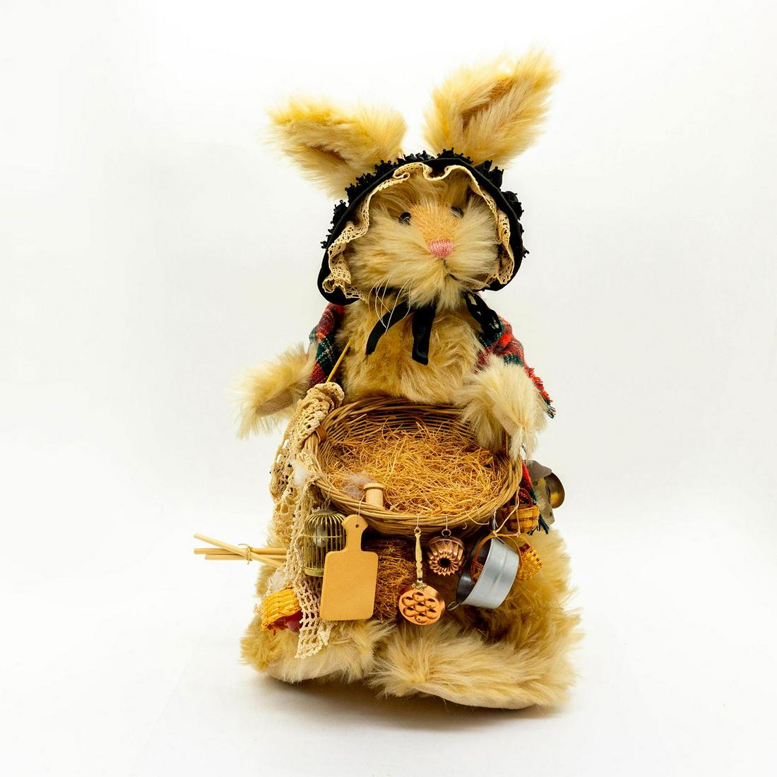 Pearls Stuffed Animal, The Peddler: Fully jointed, mohair, shaved snout. Wearing a plaid cloth over back and a black hat. Holding a basket and many other smaller containers. Original tag attached. Artist: Nancy Crowe Issued: 20th c. Dim