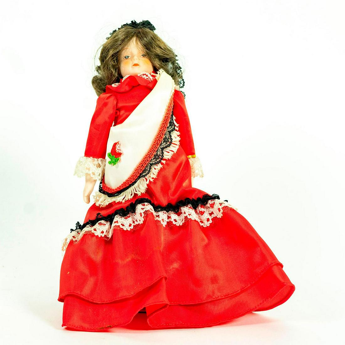 Vintage Doll, Gorham, Marisa: Doll adorned in red dress with white laced edging and black veil over her head. Original label on right arm. Original warning label on right arm. Original tag under dress. Attached to stand. Issued: 1