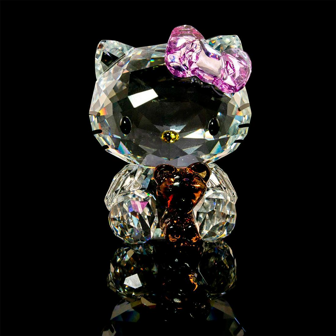Swarovski Crystal Figurine, Hello Kitty Bear 1096879: Clear, Sanrio glass cat figure, holding bear. With original box. Swarovski backstamp. Issued: 20th c. Dimensions: 2.5"H Manufacturer: Swarovski Country of Origin: Austria