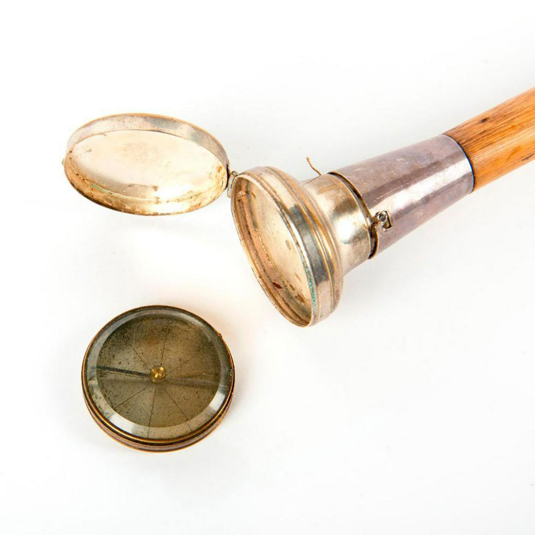 Gadget Compass And Alcohol Torch Cane: Compass and alcohol torch cane/walking stick. With a moveable knob. Inside is an alcohol torch. 3 ft long shaft is made of partridge wood. Sterling collar. Handle is nickel plated brass. Ferrule is 1.