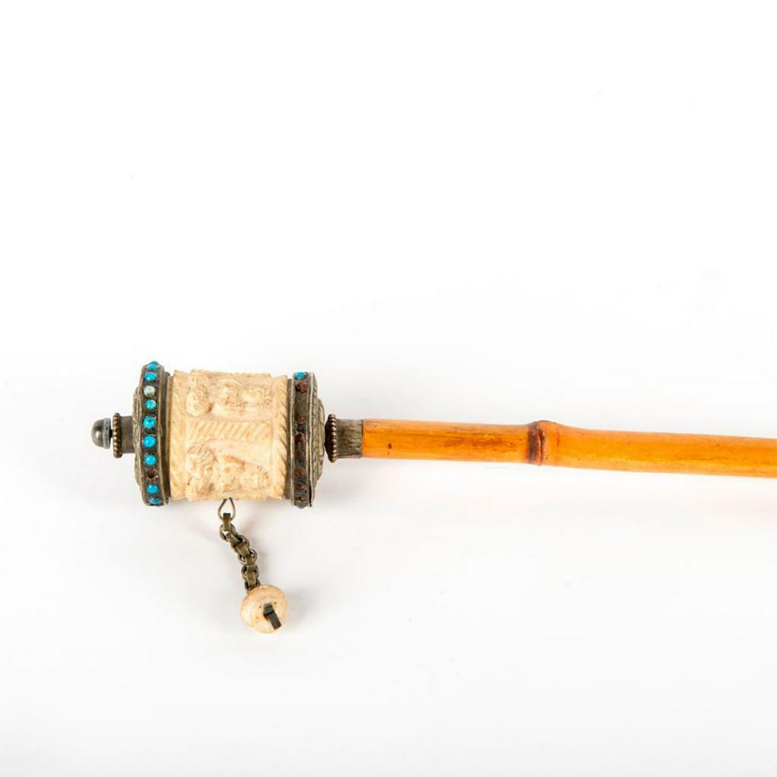 Gadget Hindu Holy Prayer Wheel Cane: Hindu Holy Prayer Wheel Cane/walking stick with bone wheel. The bone wheel has carved Buddhas on it. When you swing the cane in the air the prayer wheel rotates. Shaft is 33"L Bamboo. Ferrule is 1" br