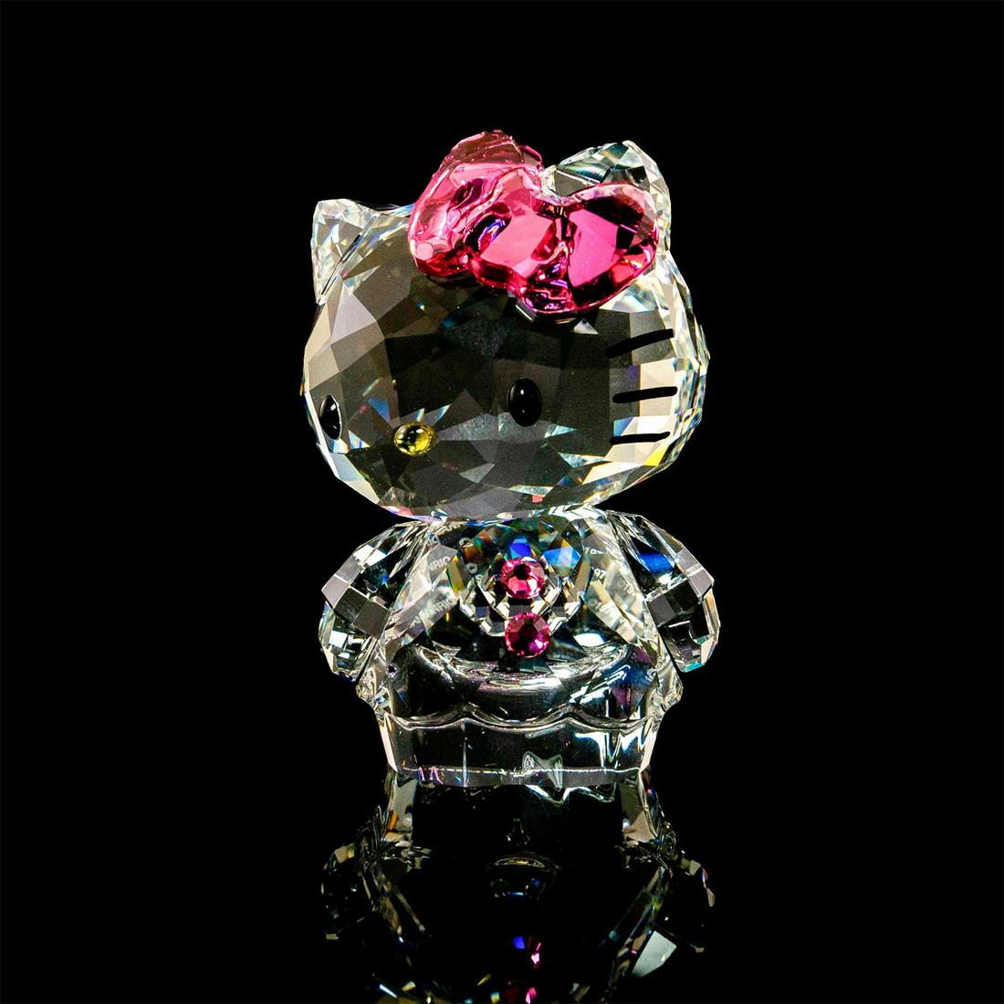 Hello Kitty Pink Bow 1096877 - Swarovski Crystal Figure: Clear, pink and black glass cat figure. With original box. Swarovski backstamp. Issued: 20th c. Dimensions: 3"H Manufacturer: Swarovski Country of Origin: Austria