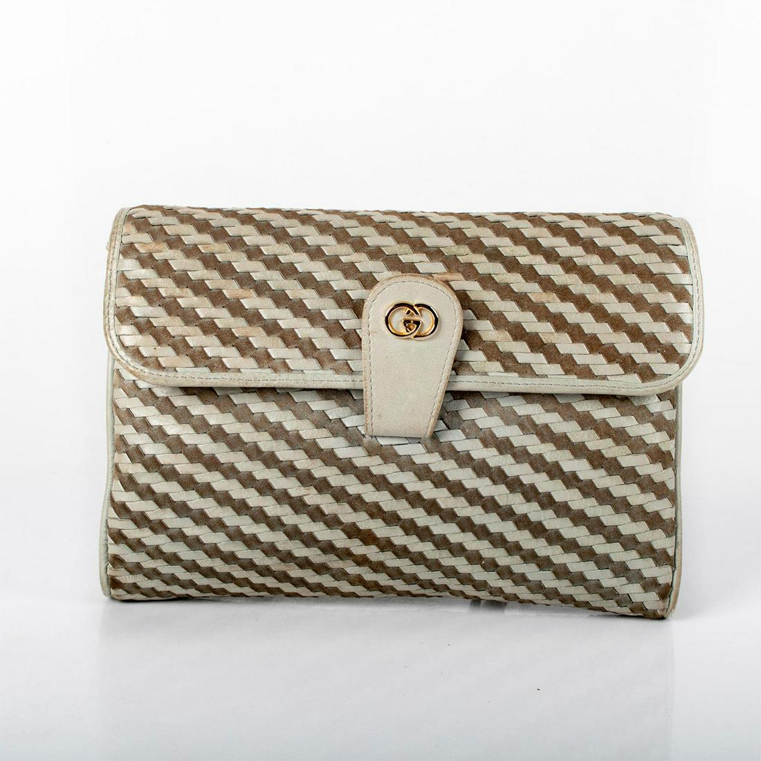 Vintage Gucci Woven Shoulder Bag: Beige colored purse crafted with woven design. Includes 2 compartments and interior zipper. Flap latch detail with buckle design on strap. Made in Italy by Gucci is embossed on interior. Timeless piec