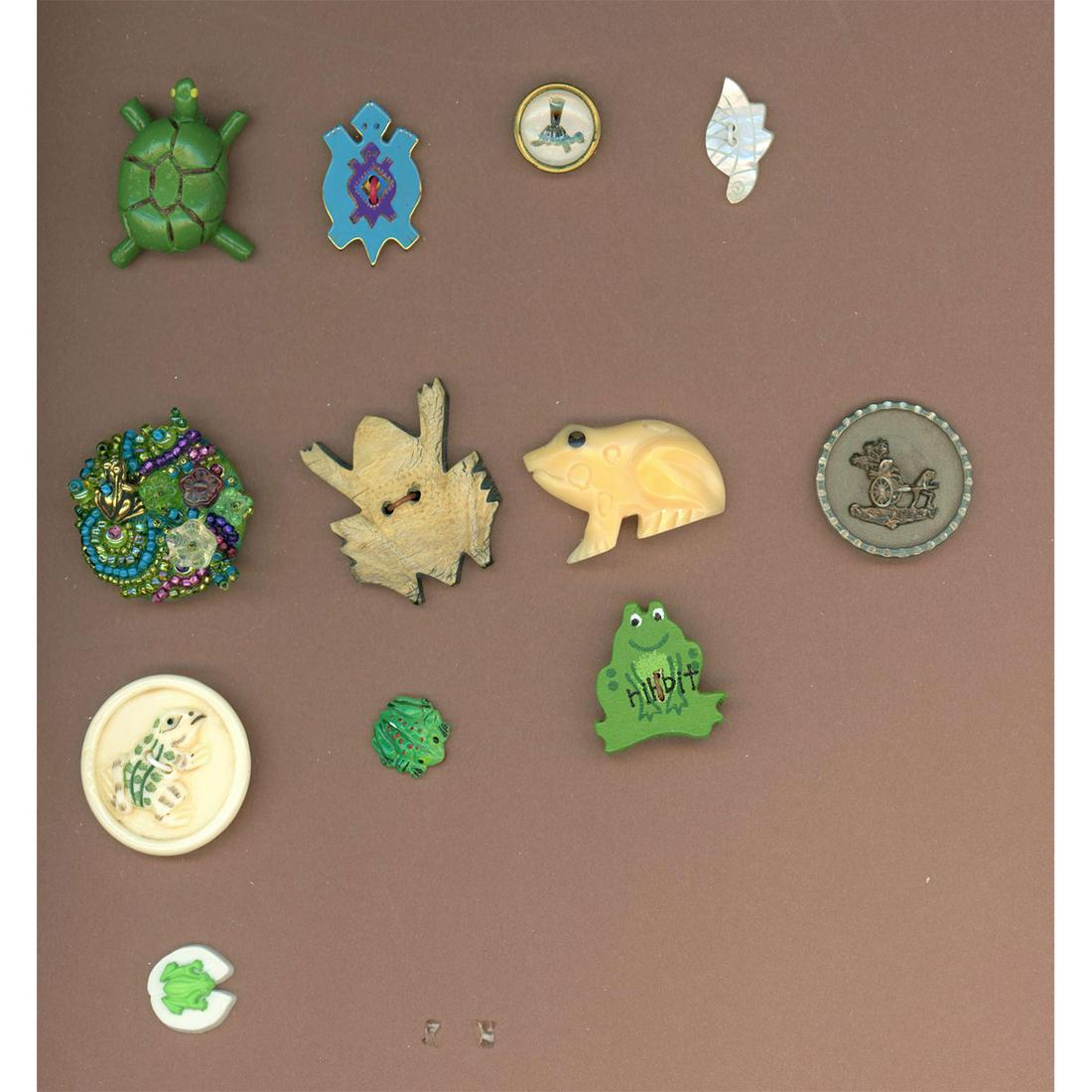 A PARTIAL CARD OF ASSORTED MATERIAL FROG BUTTONS: 12 Sm/Med/Large mostly 29th century frog buttons. The lot includes bone, beaded fabric, plastic, a Laurel Birch sew thru as well as a 19th century division one picture button of frogs pulling a cart a