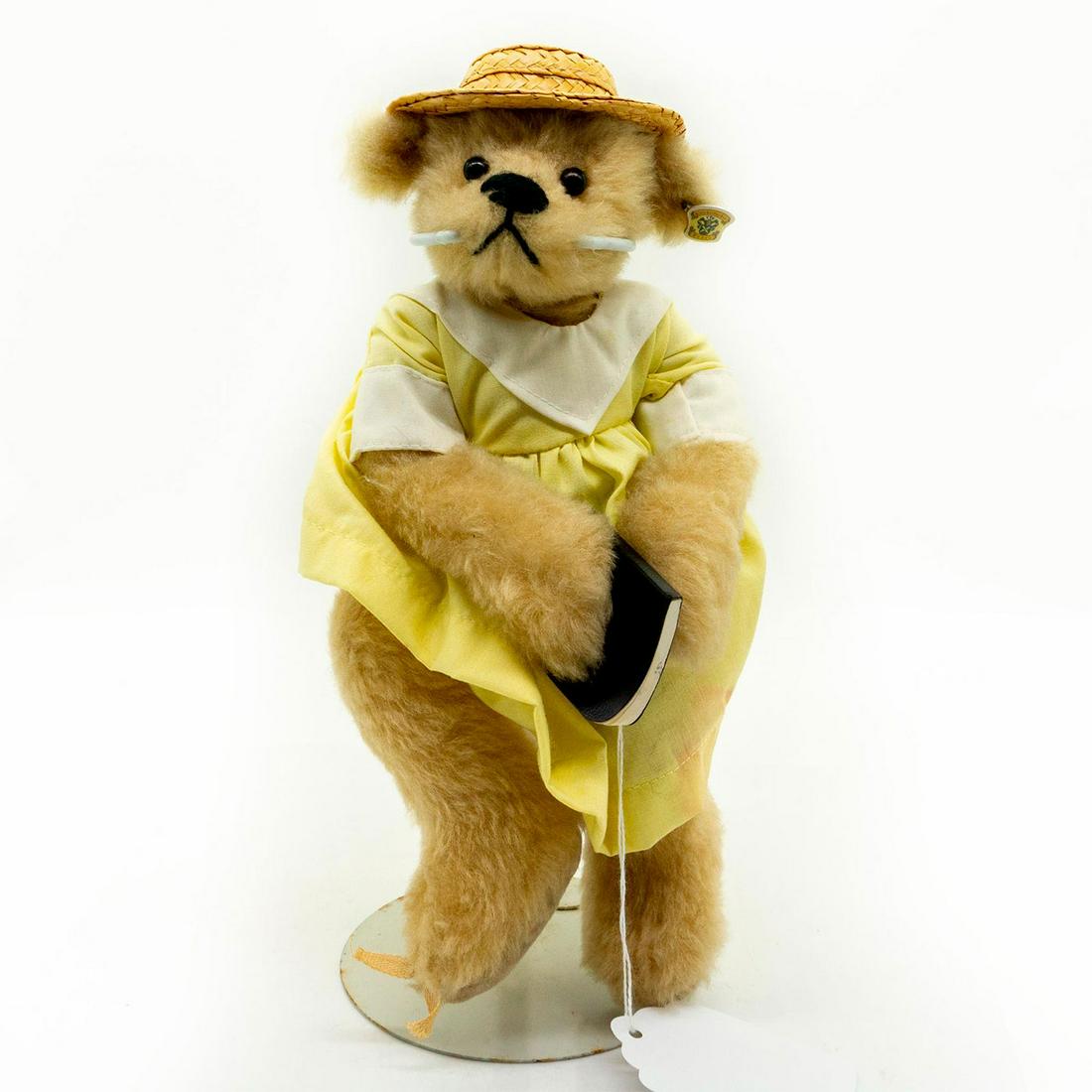 Bearly There Company Teddy Bear, Straw Hat Praying: Fully jointed, plush, glass eyes, sewn nose. Wearing yellow dress and holding a bible. Original tag attached and display stand included. #strawhat #yellowdress #bible #prayer #religion Issued: 20th c.