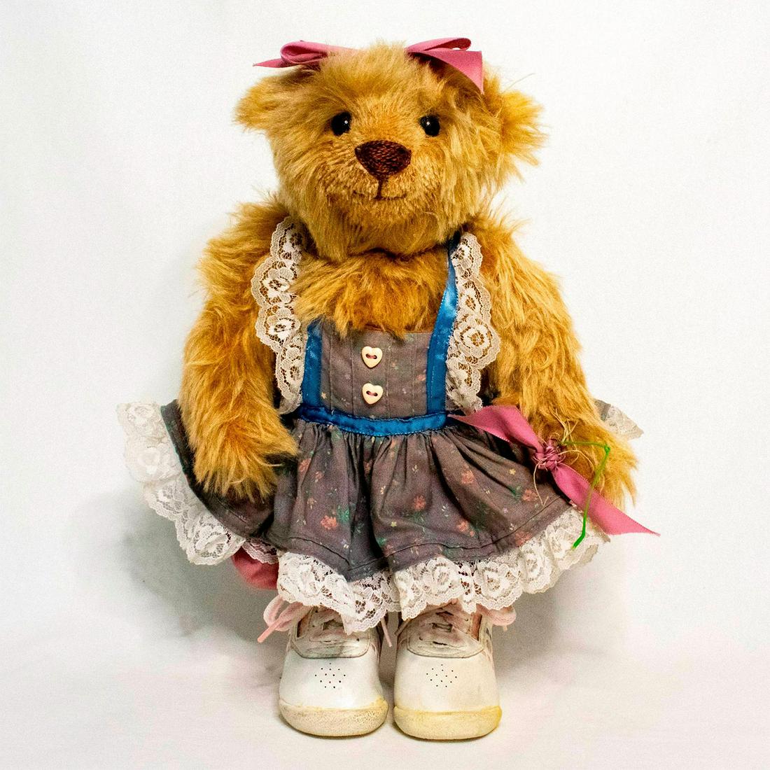 Flora Mediate Flora's Teddys, Birthday Girl: Tan bear wearing grey floral apron with lace trim, mauve pants, Pro Wings sneakers, and mauve bow on head. Custom designed by Flora Mediate. The original signed tag on the back. Imported mohair. Joint