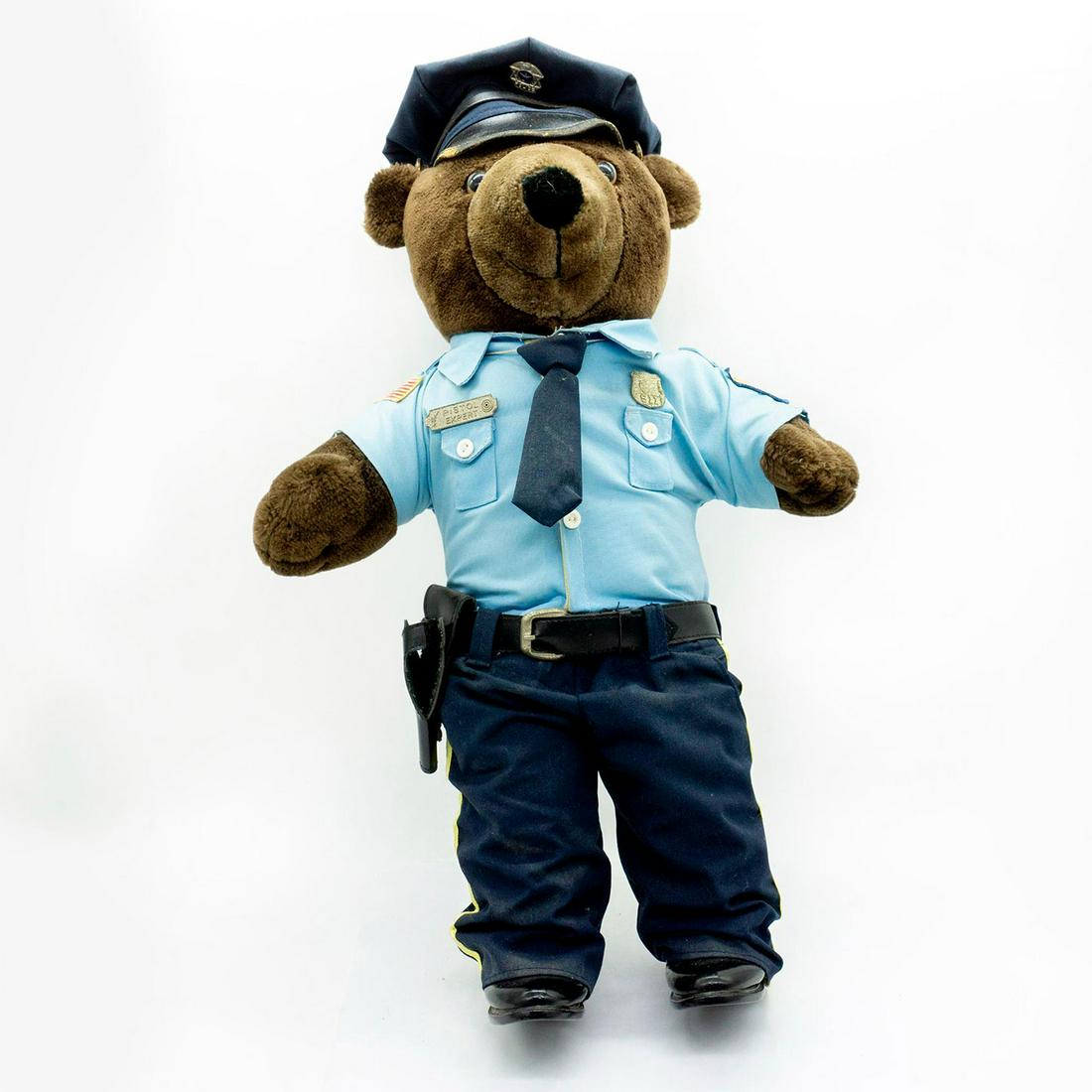 J.J. Wind Inc. Patriot Bear Police Pistol Expert Teddy: Dark brown teddy bear is wearing light blue and navy blue police uniform. Silver toned metal -Pistol Expert- and -American Police 911- pins on the chest. #Teddybear #childrentoy Issued: c. 1980 Dimens
